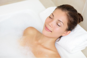 woman in bath with eyes closed