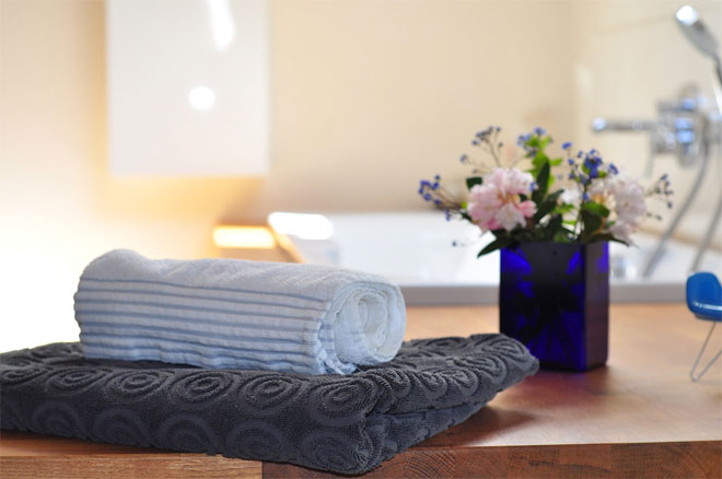 Towels and a potted plant to add character to a bathroom